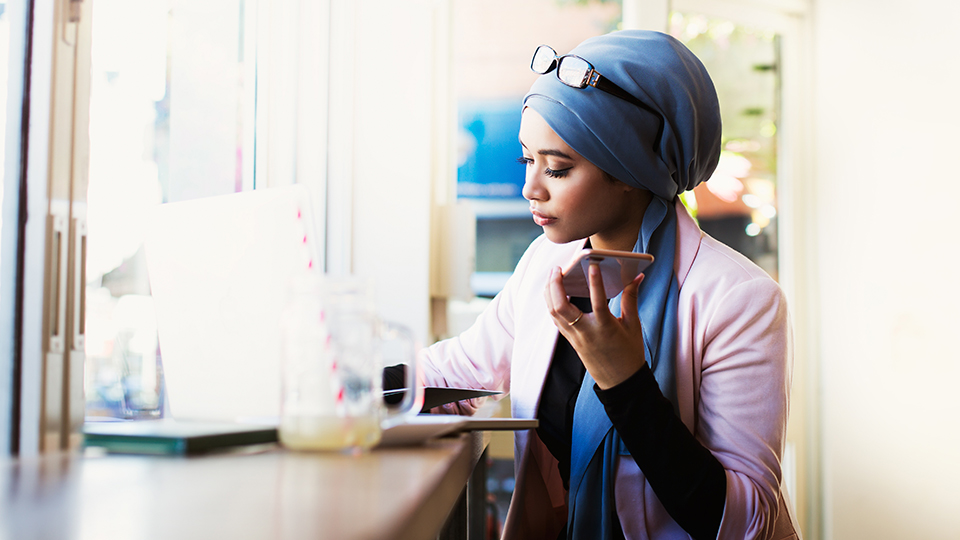 A young person sitting indoors by the window